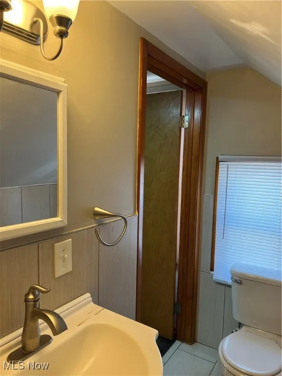 Bathroom with a wainscoted wall