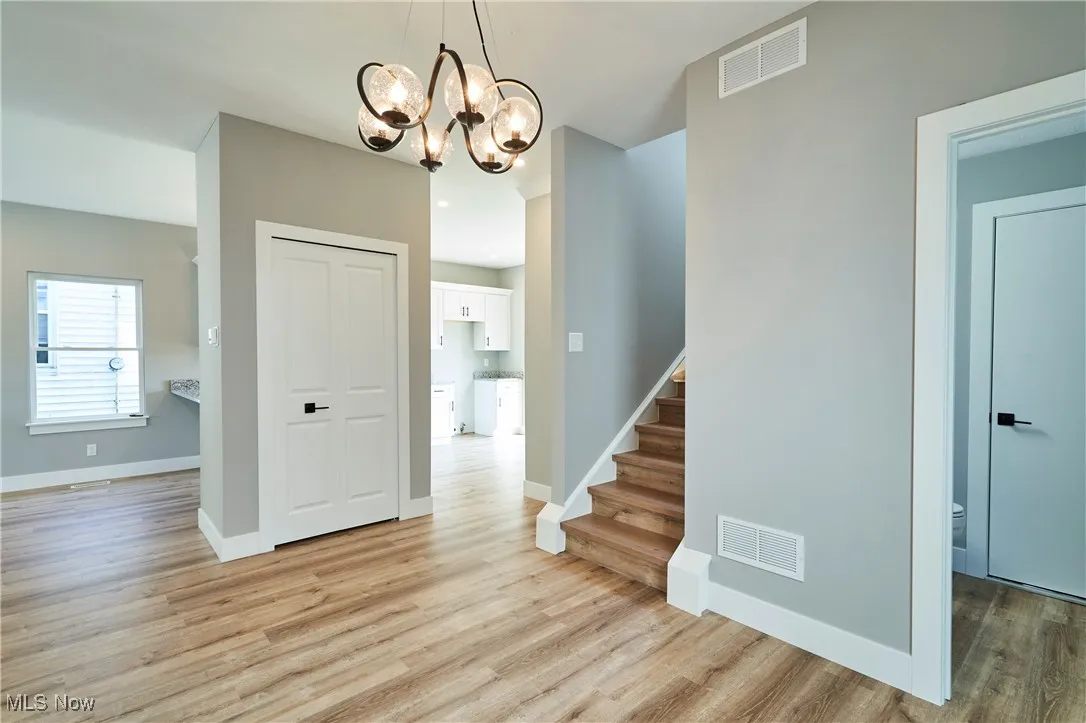 Foyer featuring a chandelier and light wood-type flooring