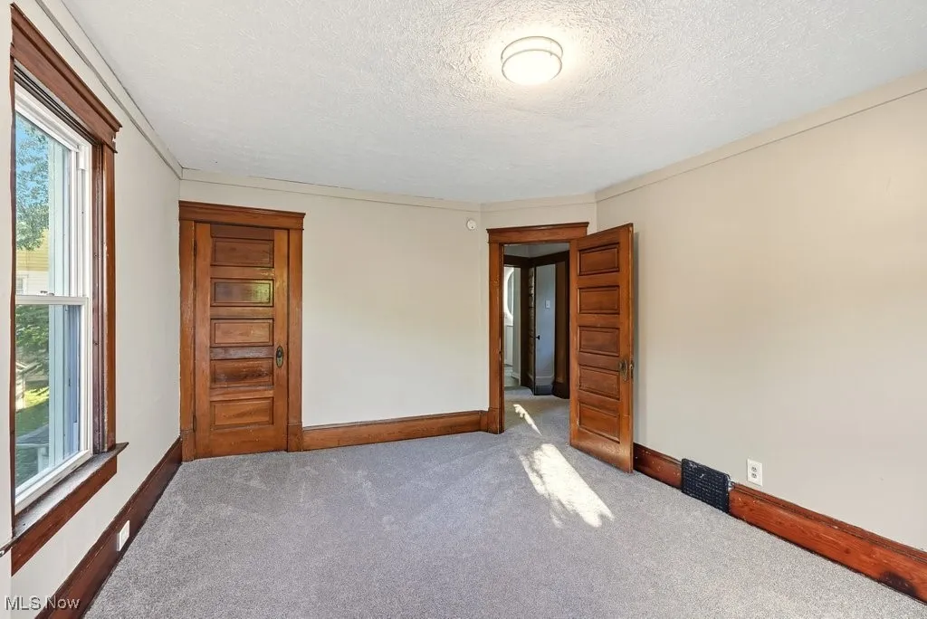 Spare room featuring carpet flooring and a textured ceiling
