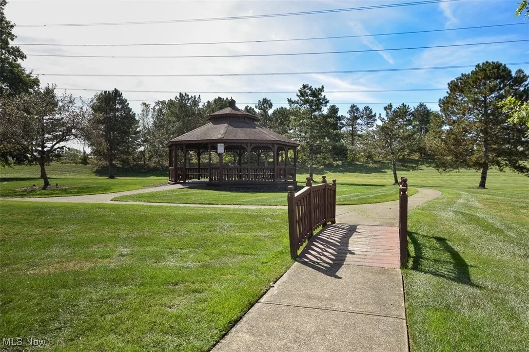 Surrounding community with a lawn and a gazebo