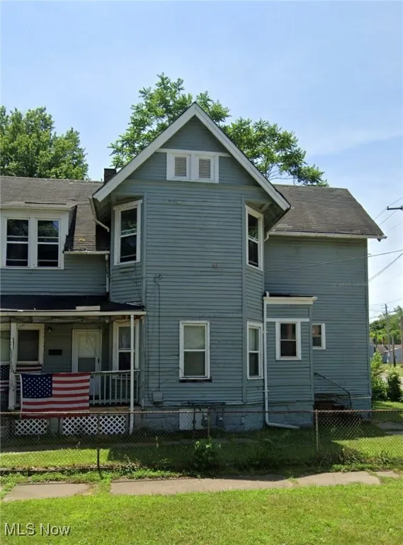 View of side of home with a fenced front yard
