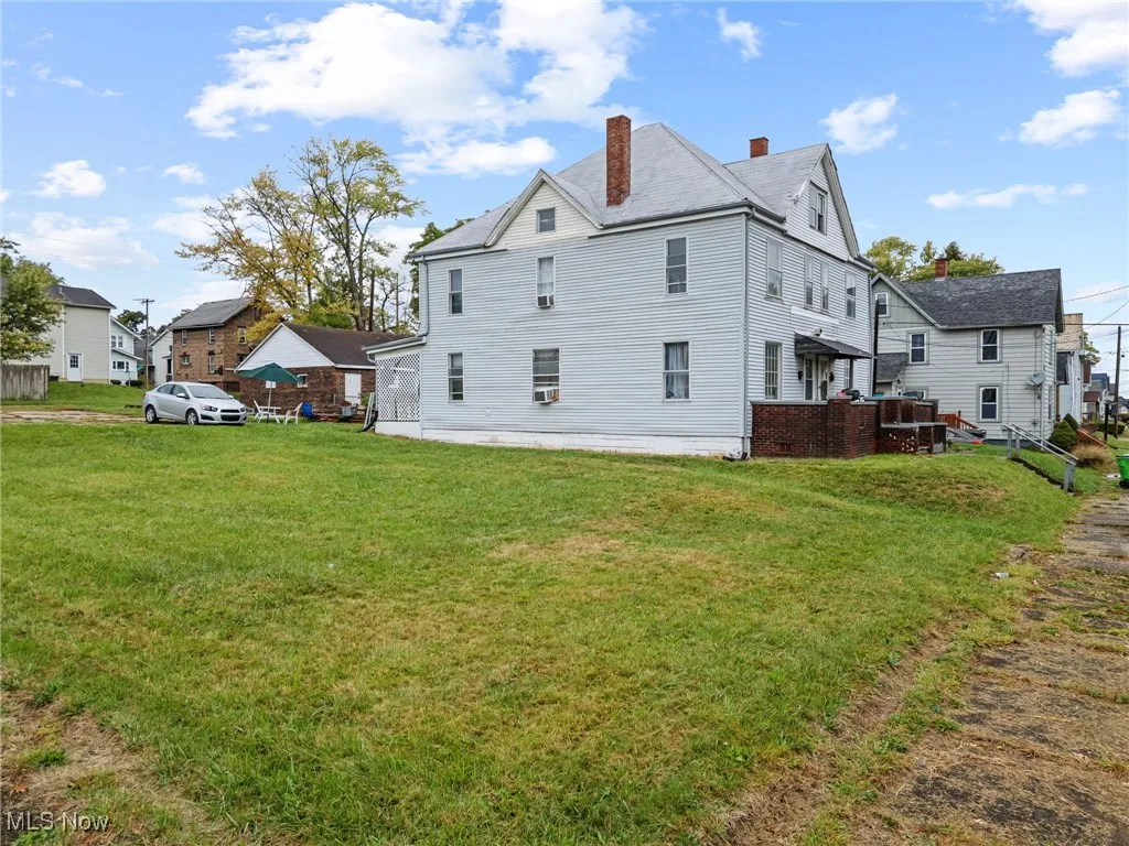 Back of property featuring a lawn