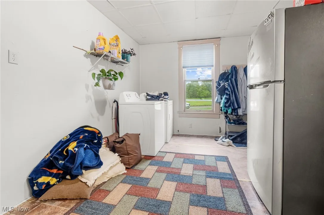 Laundry room featuring a paneled ceiling and separate washer and dryer