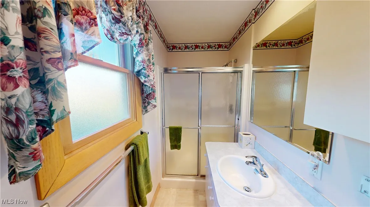 Primary bedroom private bathroom with toilet, sink and shower.