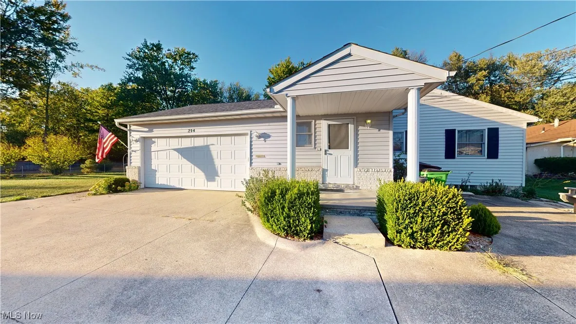 Side of the home feautring garage and side entrance into laundry room.