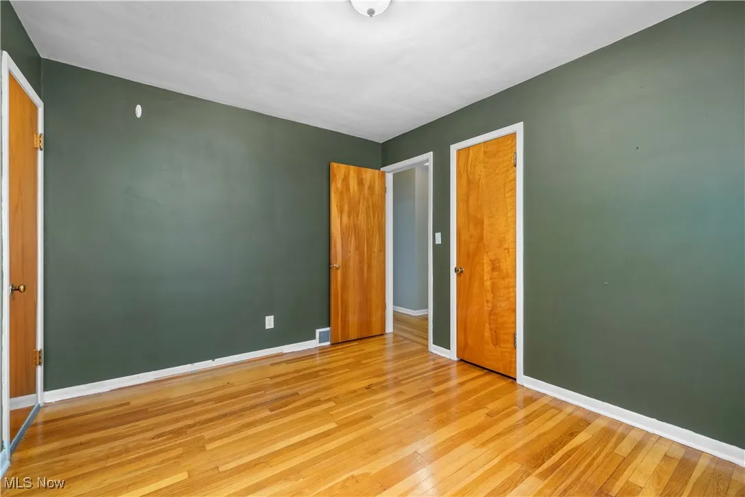 Unfurnished bedroom featuring hardwood / wood-style flooring and a closet