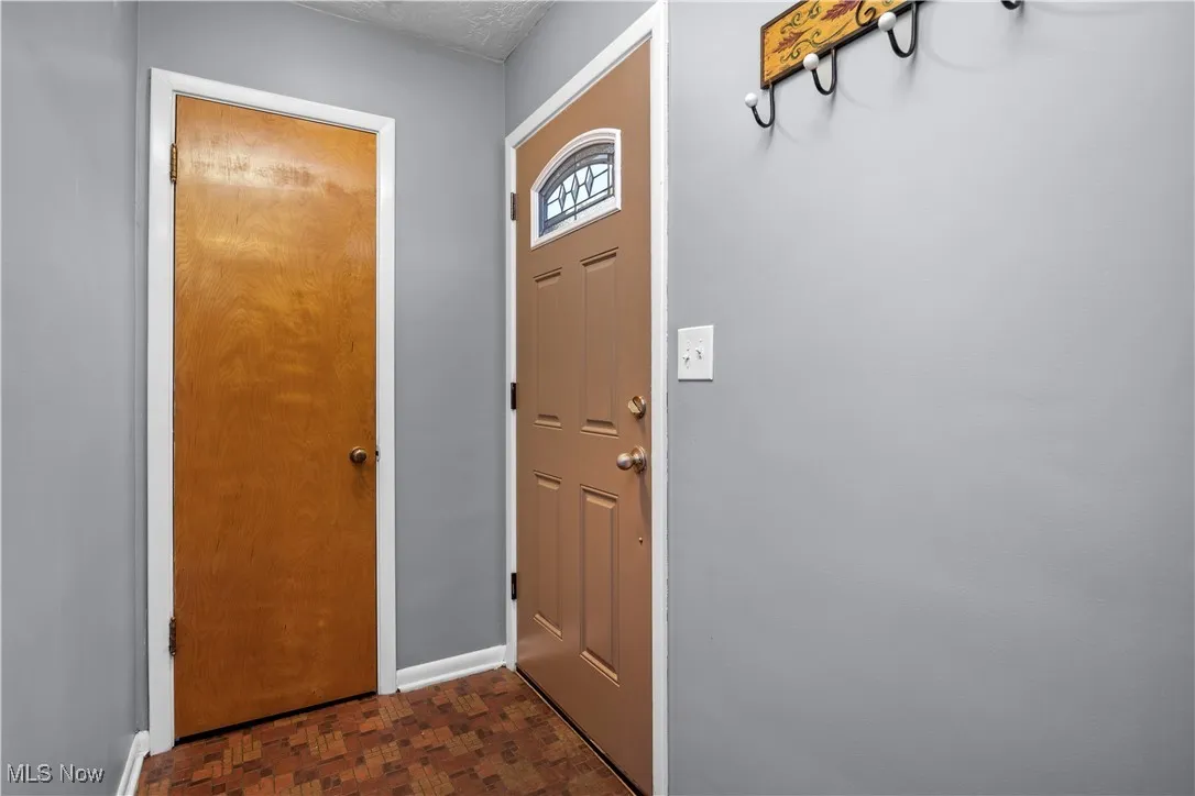 Doorway featuring baseboards