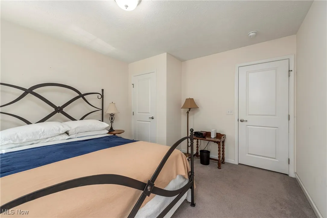 Bedroom with light carpet and baseboards