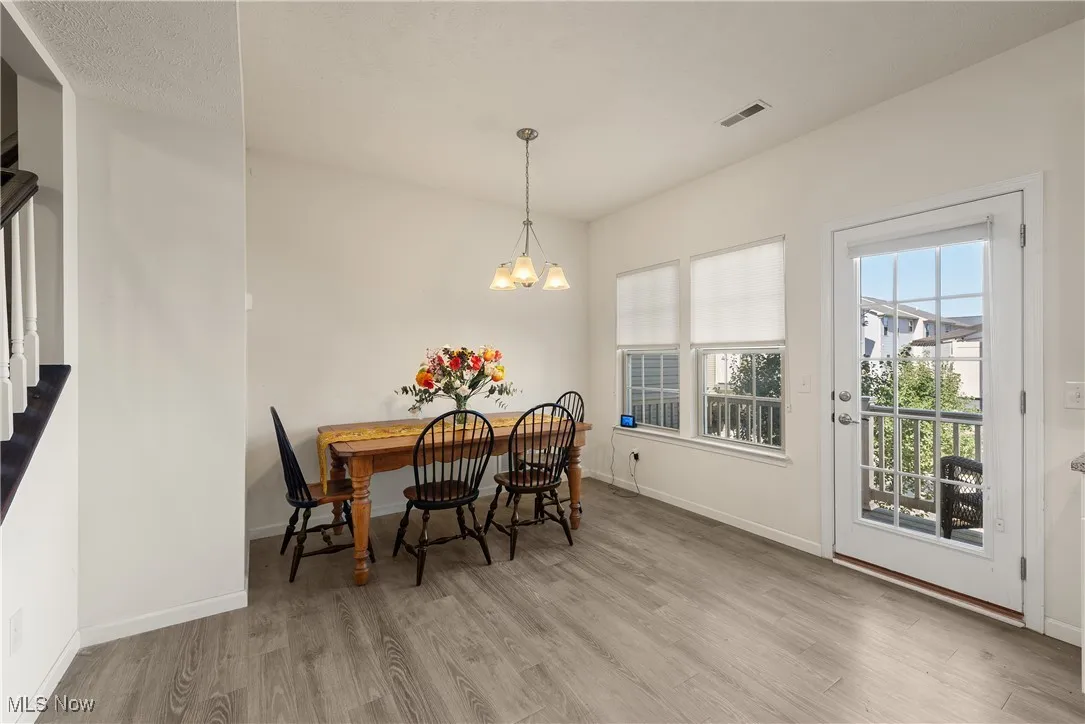 Dining space featuring light wood-style flooring and a chandelier