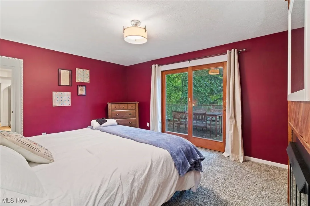 Bedroom featuring light colored carpet and access to outside