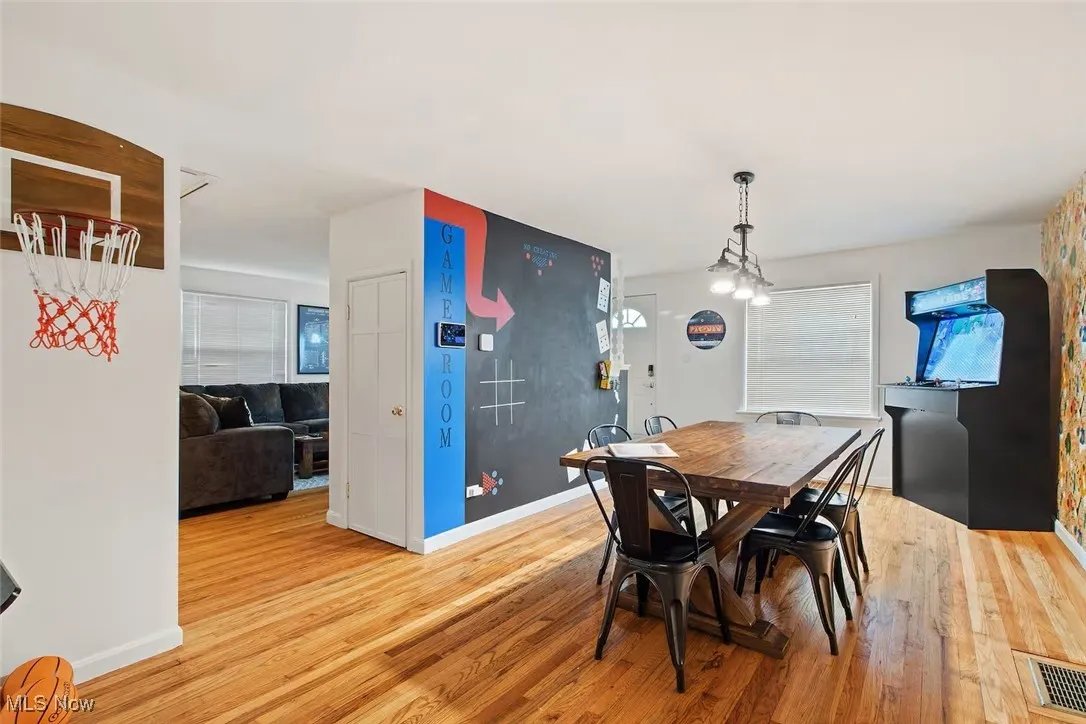 Dining space featuring light wood-style floors and a chandelier