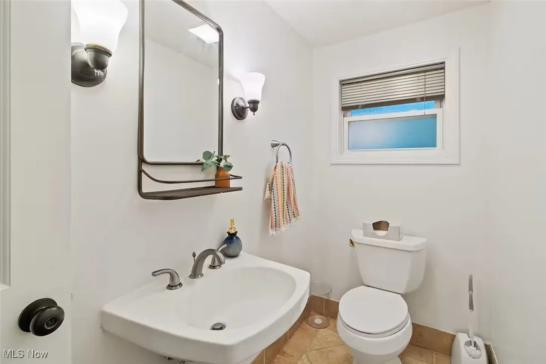 Bathroom with toilet and tile patterned flooring