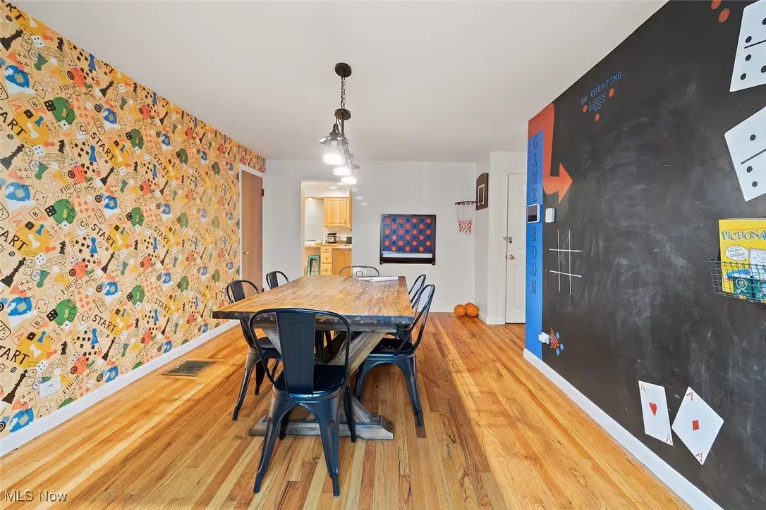 Dining room featuring light wood finished floors and baseboards