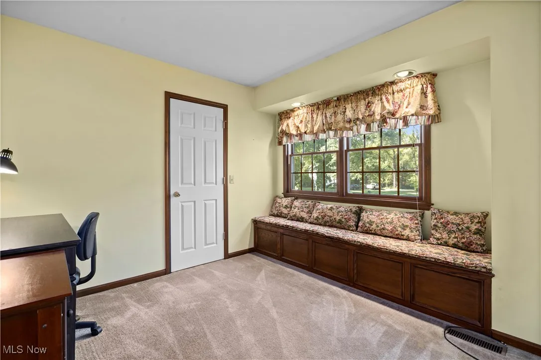 Sitting area in primary bedroom with bay window