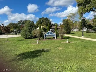 View of home's community with a yard