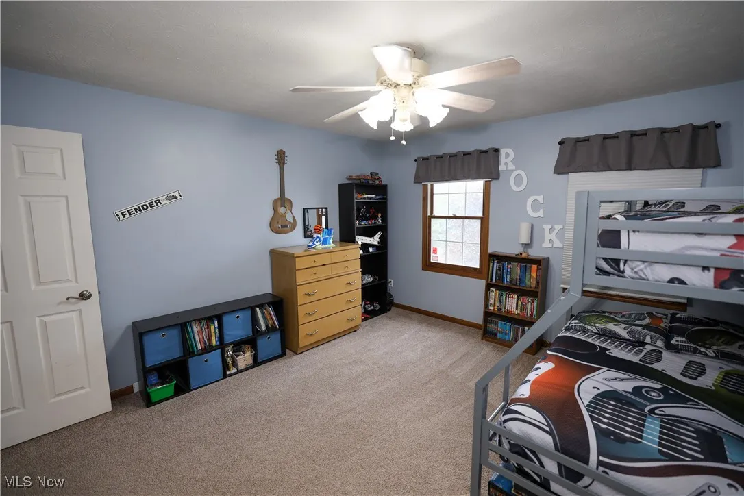 Bedroom featuring light colored carpet and ceiling fan