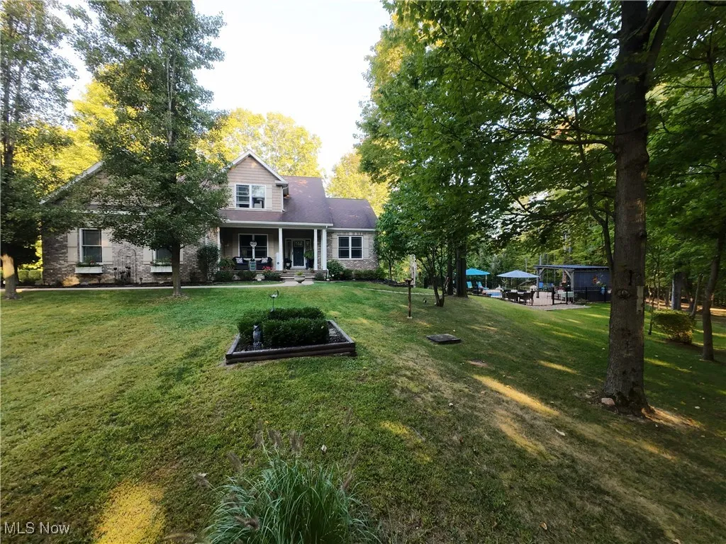 View of front of house featuring covered porch and a front lawn