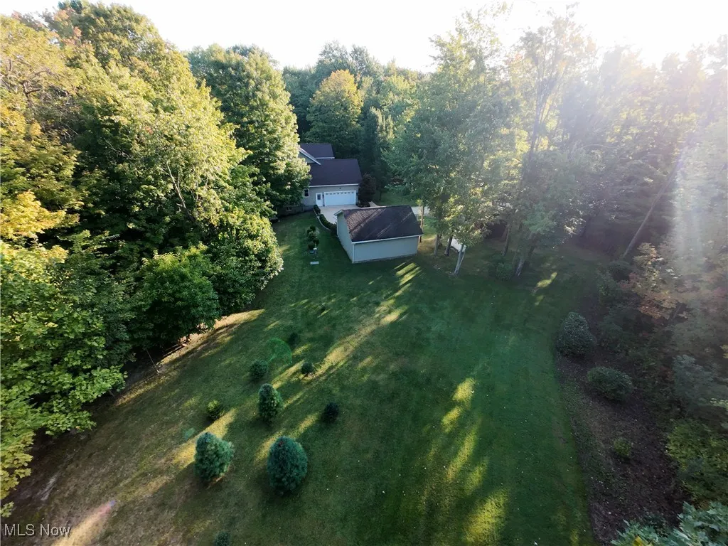Aerial view of property and surrounding area featuring a​​‌​​​​‌​​‌‌​‌‌​​​‌‌​‌​‌​‌​​​‌​​ forest
