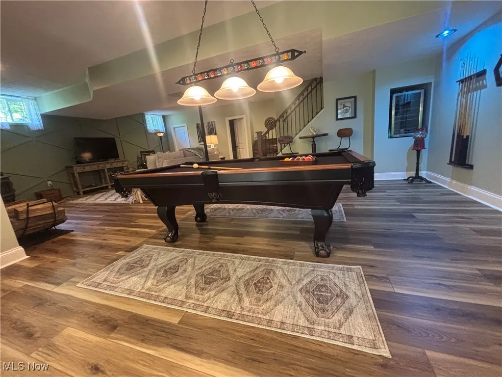 Recreation room with billiards and dark wood-style floors