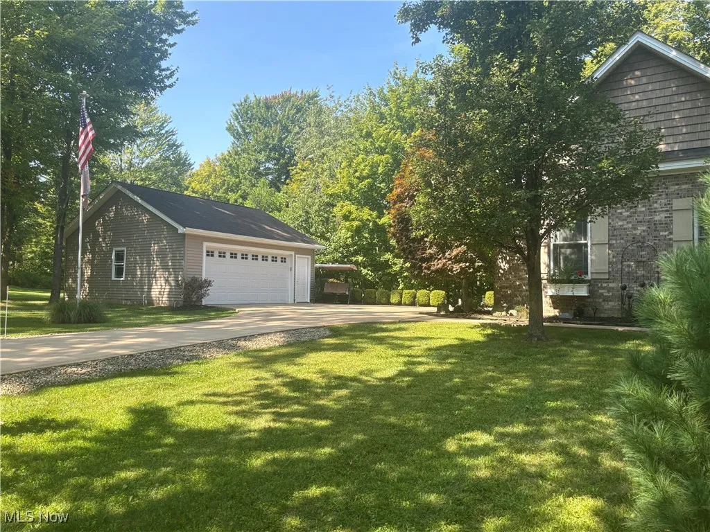 View of two car garage (detached). Two car attached garage also with entry to laundry room