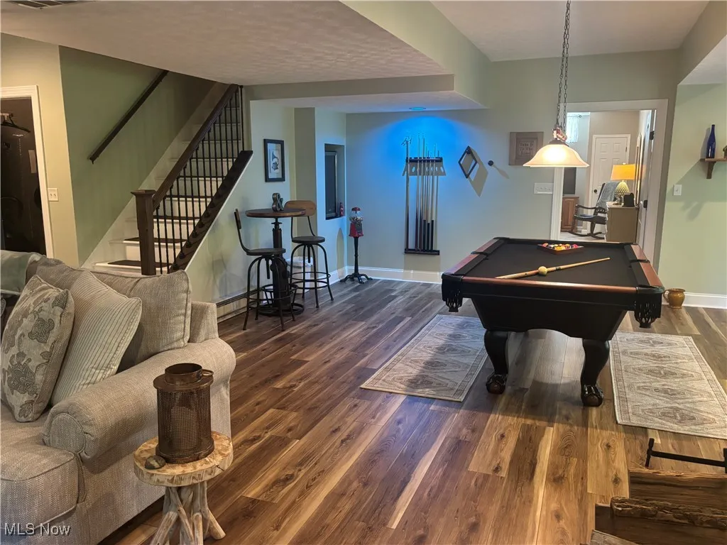 Recreation room featuring pool table and dark wood-type flooring