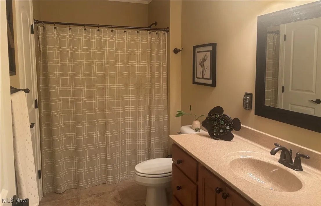 Upstairs Full bath featuring vanity, a shower with shower curtain, and light tile patterned flooring
