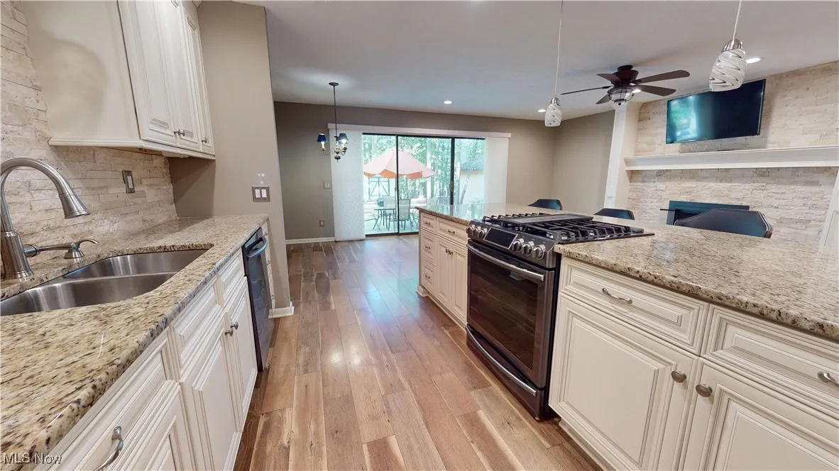 Property entrance with a shingled roof and stone siding