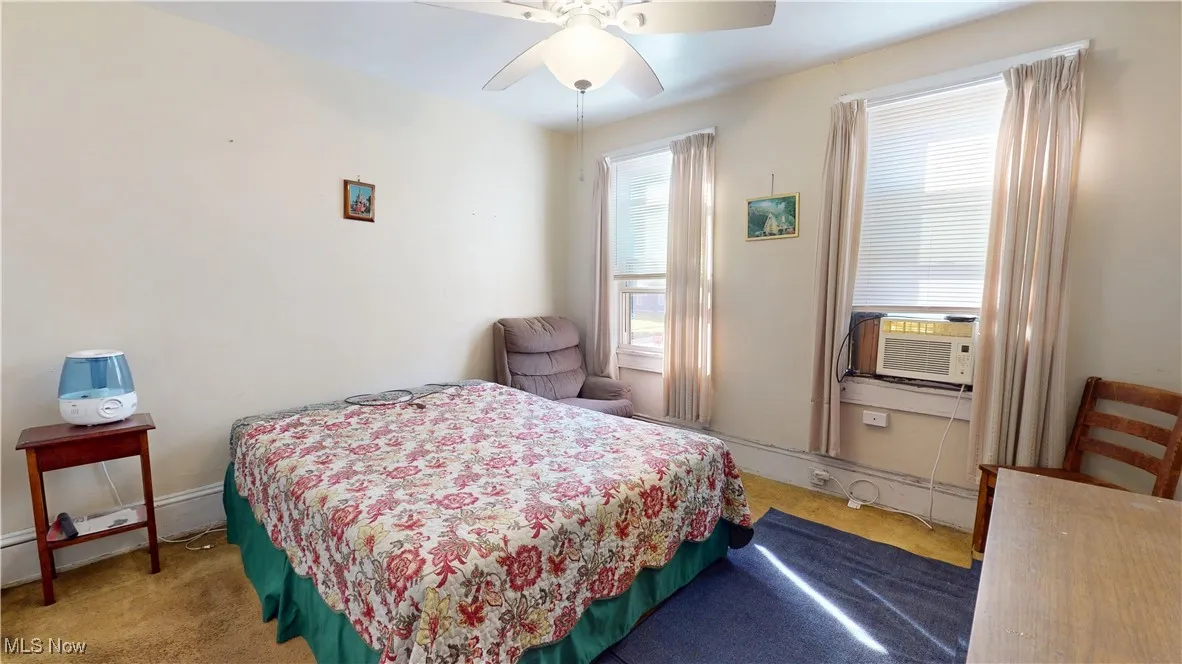 Bedroom featuring ceiling fan and cooling unit