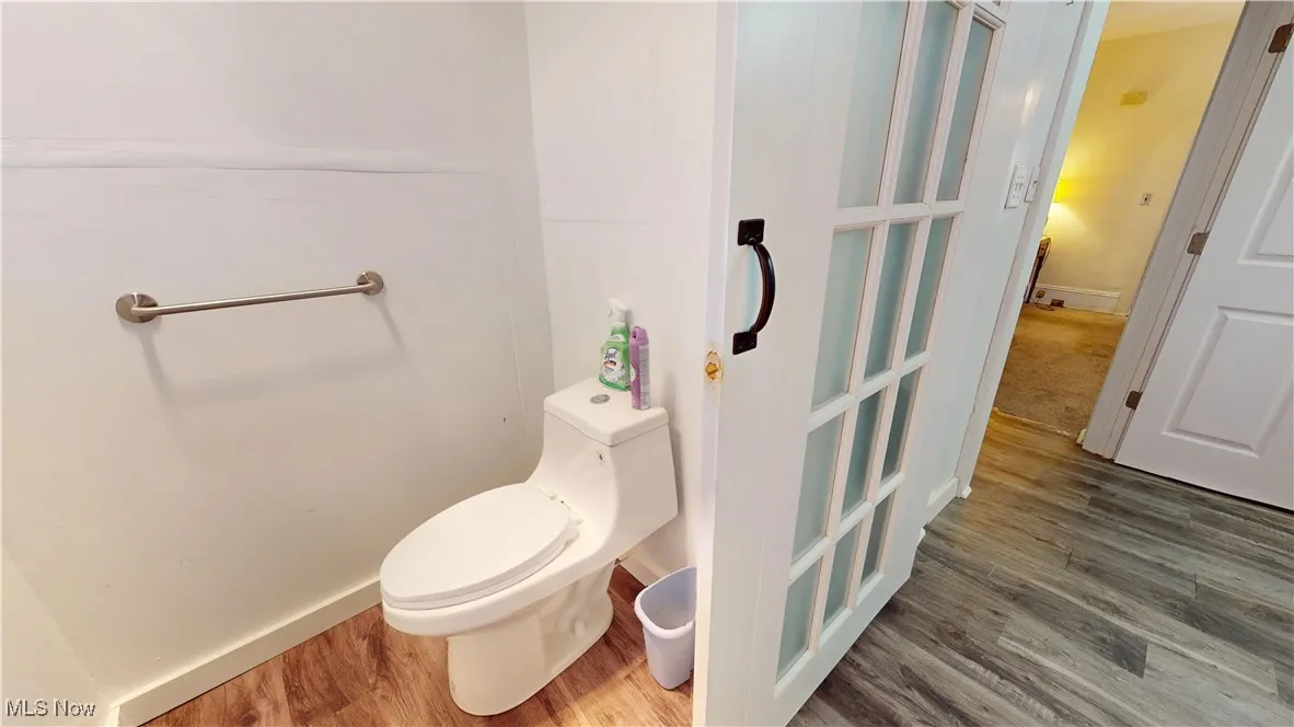 Bathroom with wood finished floors and toilet