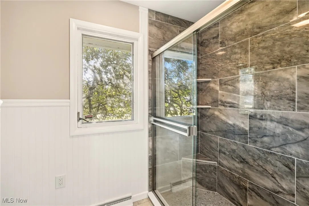 High end natural stone surround and new shower doors