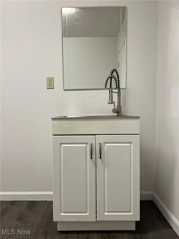 Detailed view of baseboards and wood finished floors