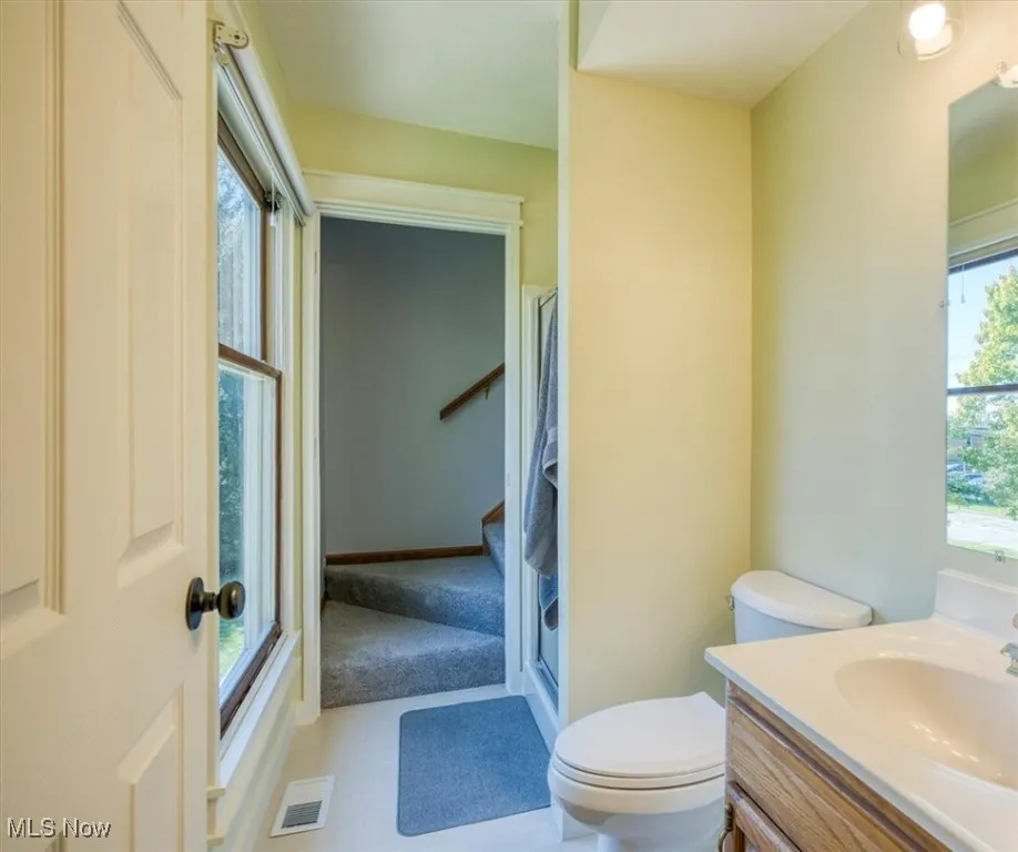 Full bathroom featuring vanity and a shower stall