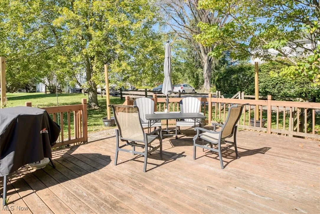 Wooden deck featuring grilling area and a lawn