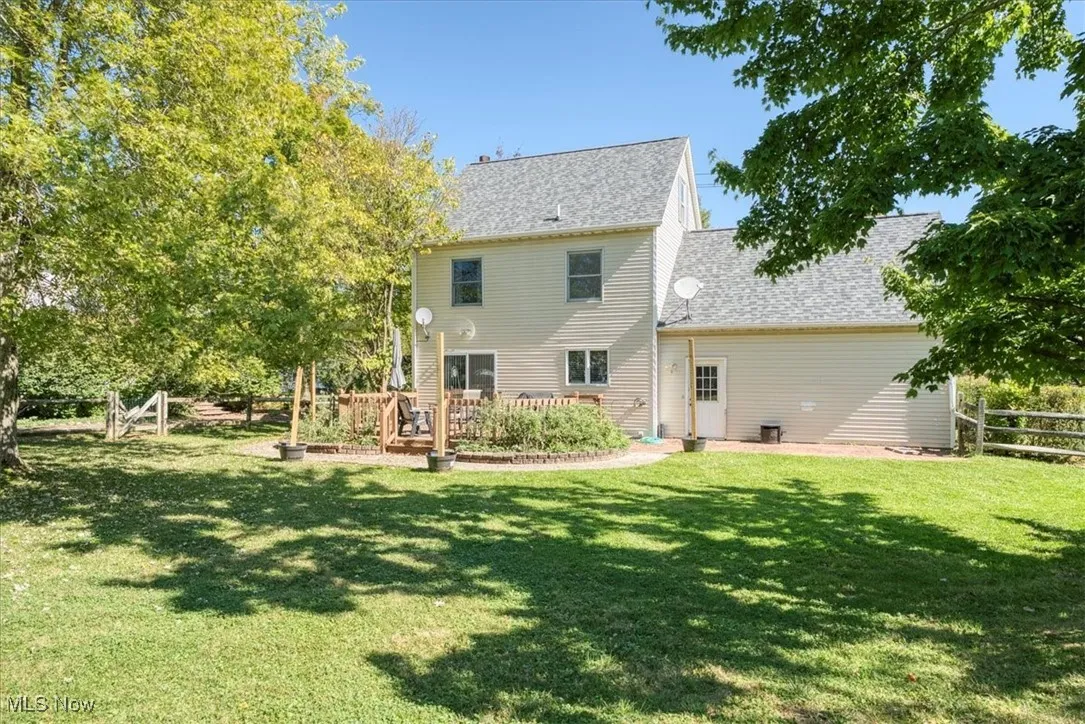 Rear view of property featuring a shingled roof