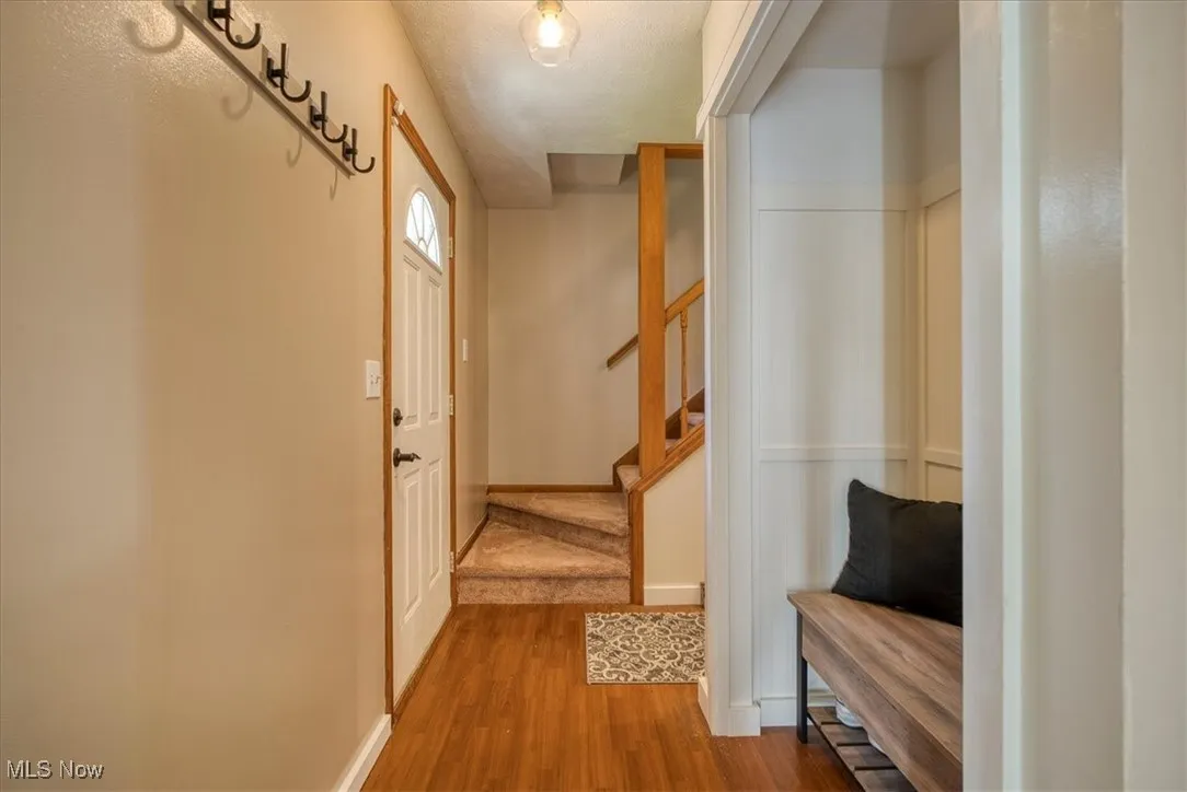 Mudroom with wood finished floors and a textured ceiling