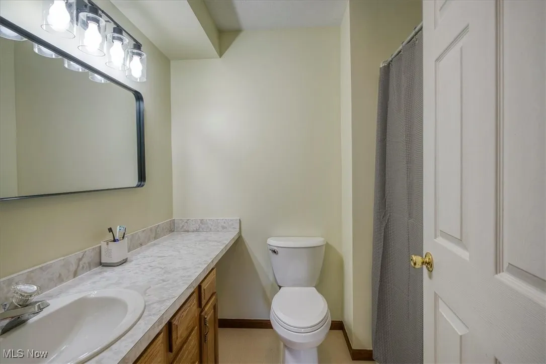Full bath featuring vanity and a shower with shower curtain