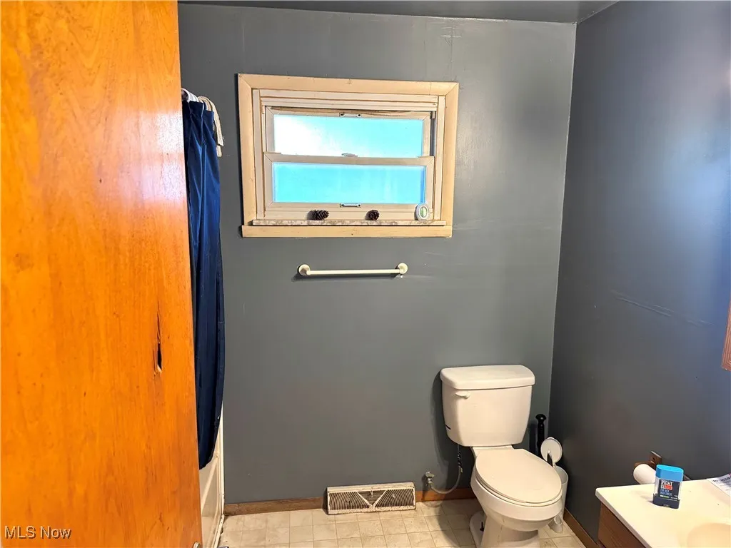 Full bathroom with shower / bath combo and vanity