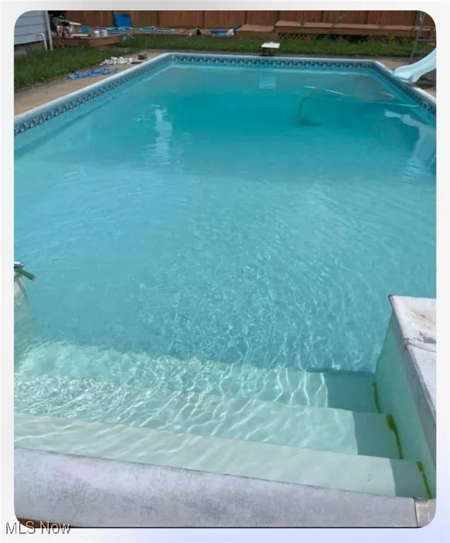 Outdoor pool featuring a water slide