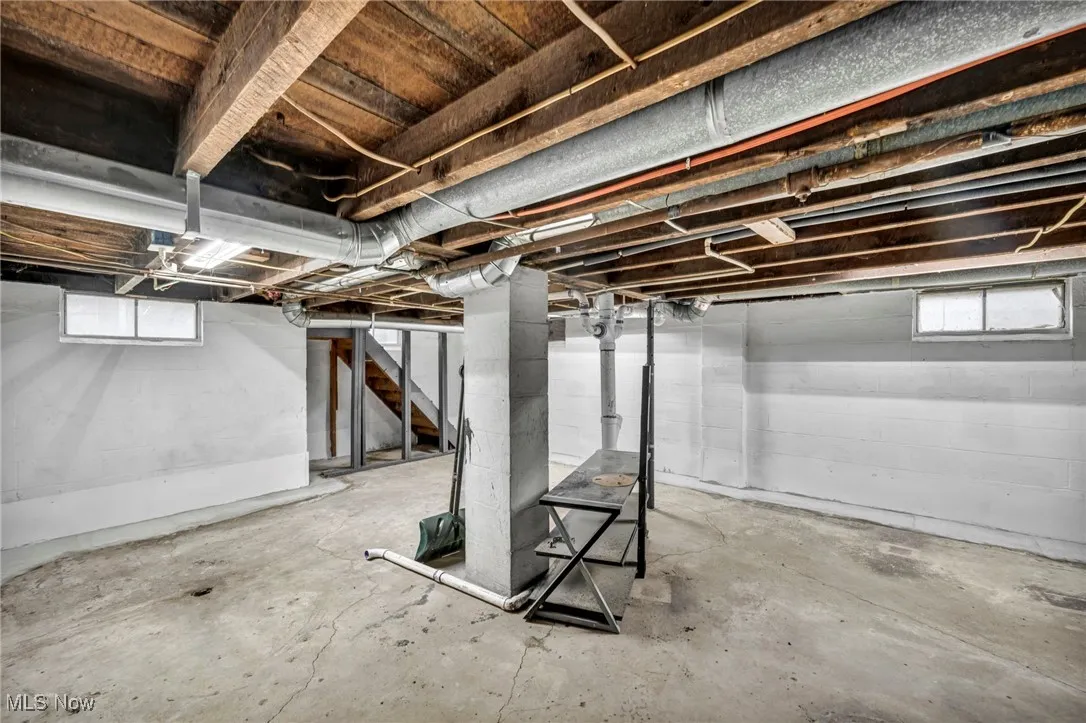 Basement featuring plenty of natural light and stairway