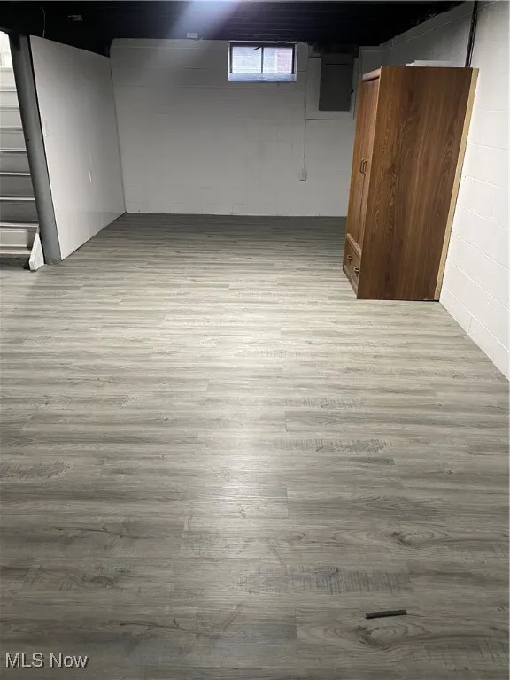 Below grade area featuring wood finished floors and stairway