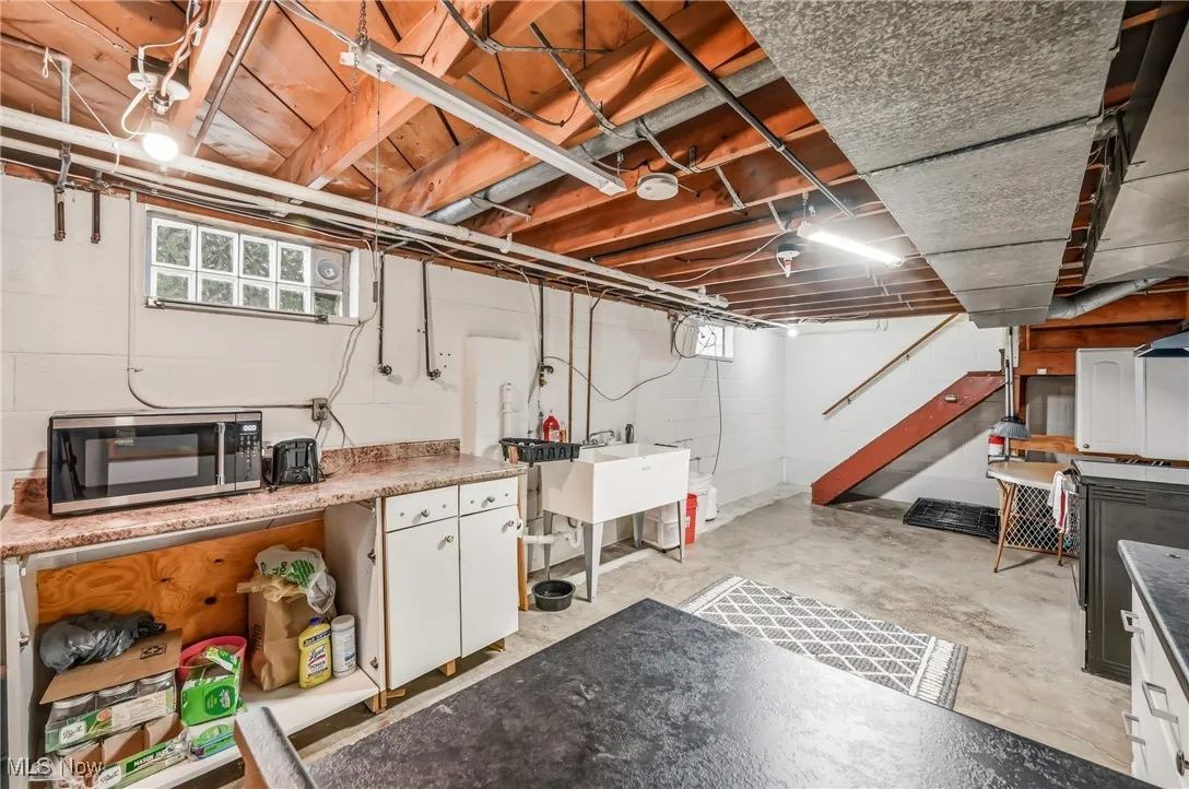 Kitchenette in basement offers secondary cooking/canning space or holiday meal prep