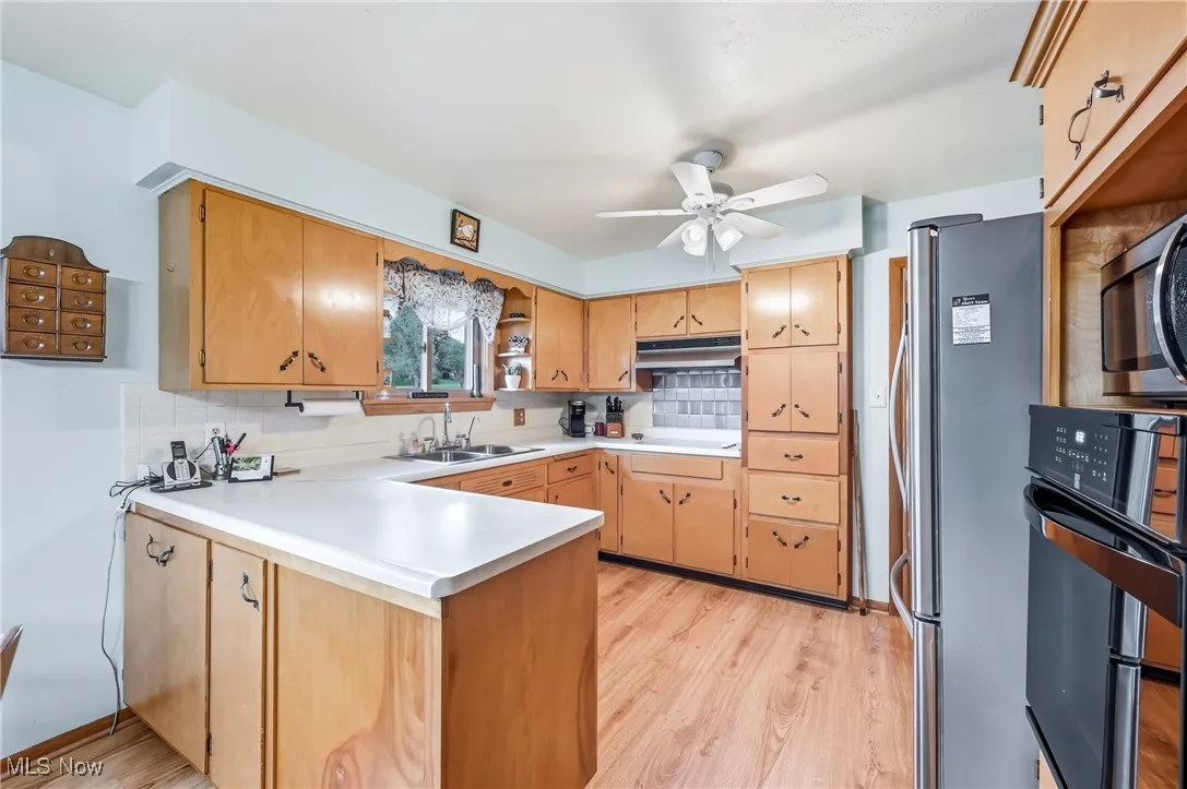 Kitchen w/ a peninsula, ample wood cabinetry