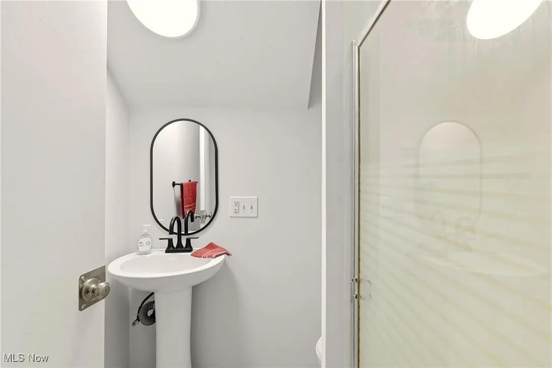 Full bathroom with a shower stall