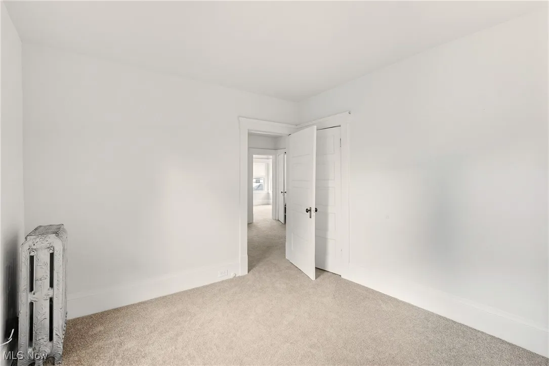 Unfurnished bedroom featuring carpet floors and baseboards