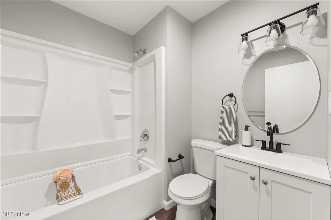 Bathroom featuring washtub / shower combination and vanity
