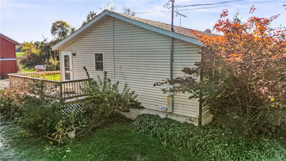 View of side of home with a deck