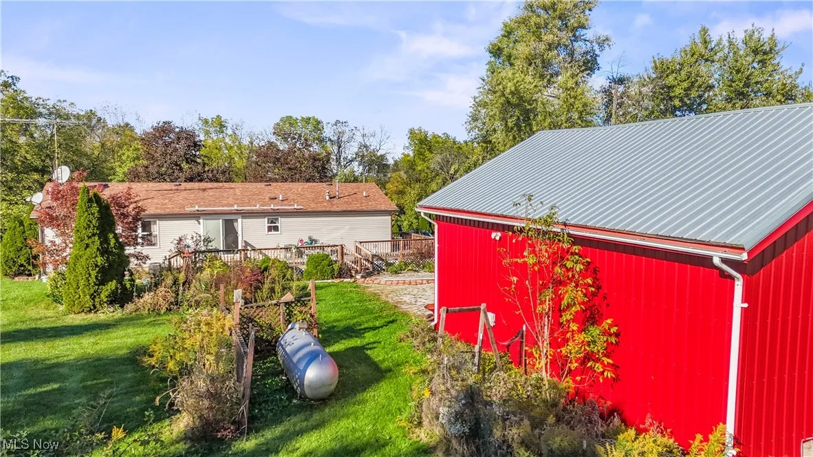 View of pole building featuring a yard