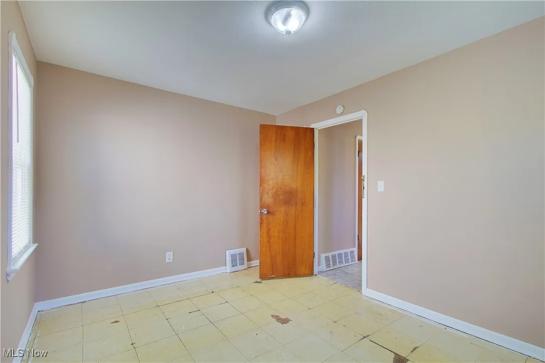 Unfurnished room with baseboards
