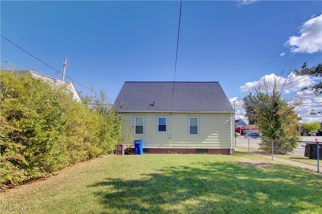 Back of property featuring roof with shingles