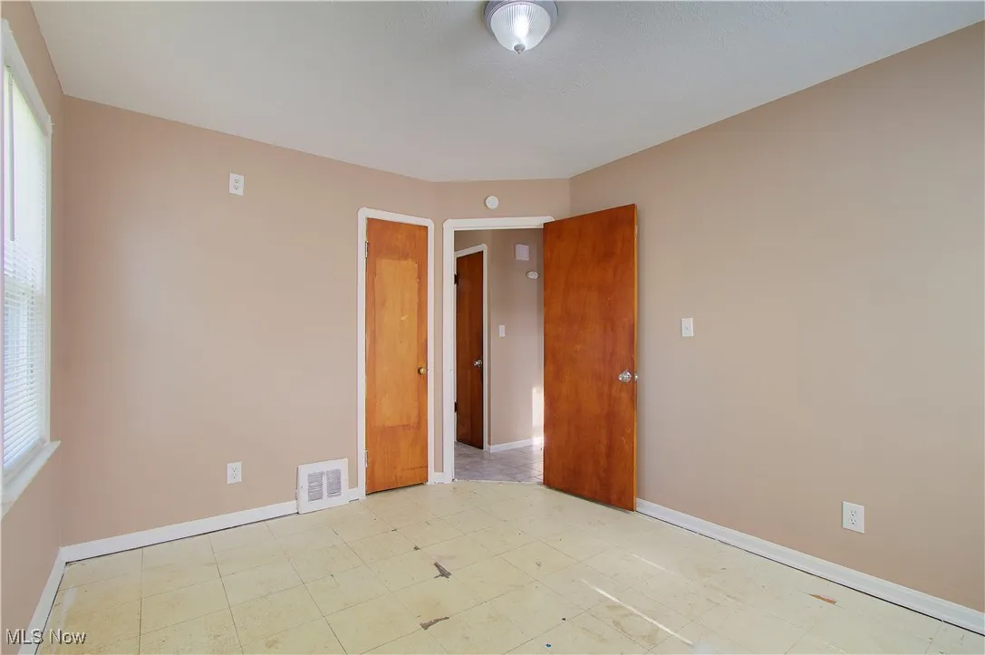 Unfurnished room featuring plenty of natural light